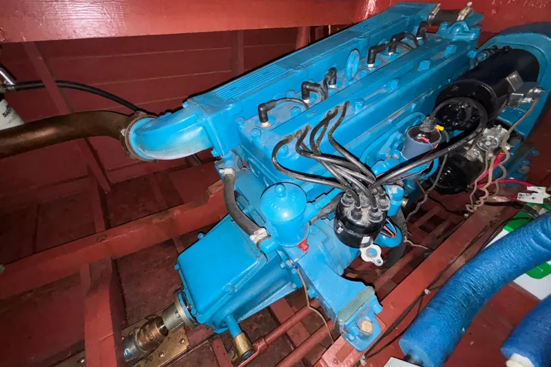 Slide: The Image of 1947 Chris Craft Barrel Back engine, vibrant blue, detailed wiring and components. - 8