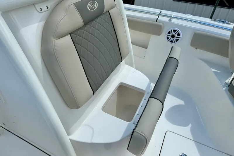 Slide: The Image of Open storage compartment on 2026 Key West 239 FS boat, featuring a white interior and metal hinge. - 22