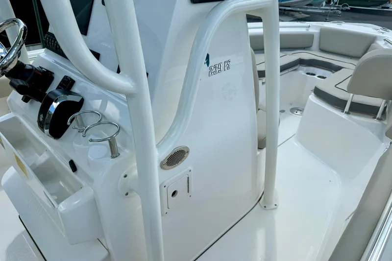 Slide: The Image of 2026 Key West 239 FS boat storage compartment with open lid, showing internal wiring. - 24