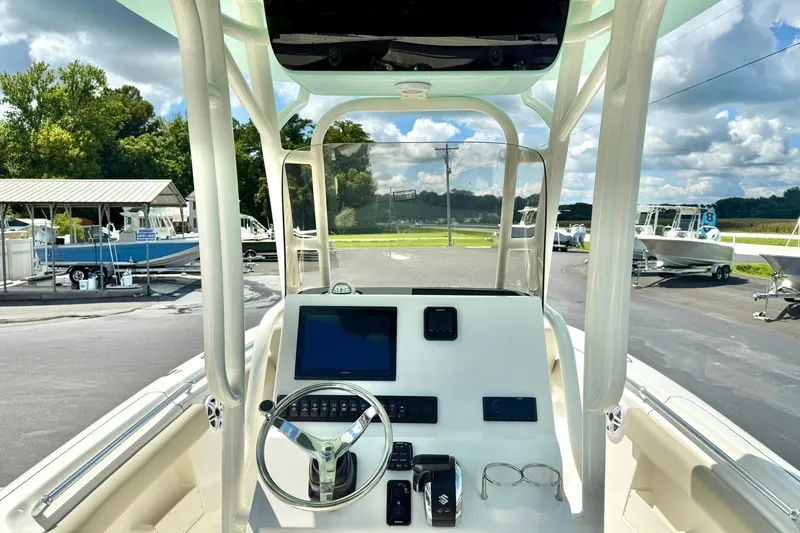 Slide: The Image of 2026 Key West 239 FS boat interior with steering wheel and seating area. - 25