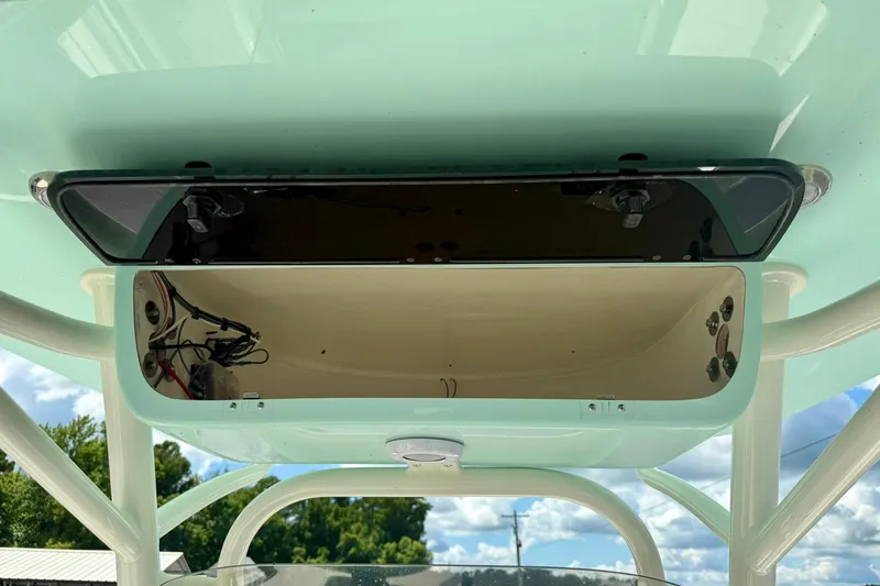 Slide: The Image of 2026 Key West 239 FS boat storage compartment with open door, showcasing interior space. - 26