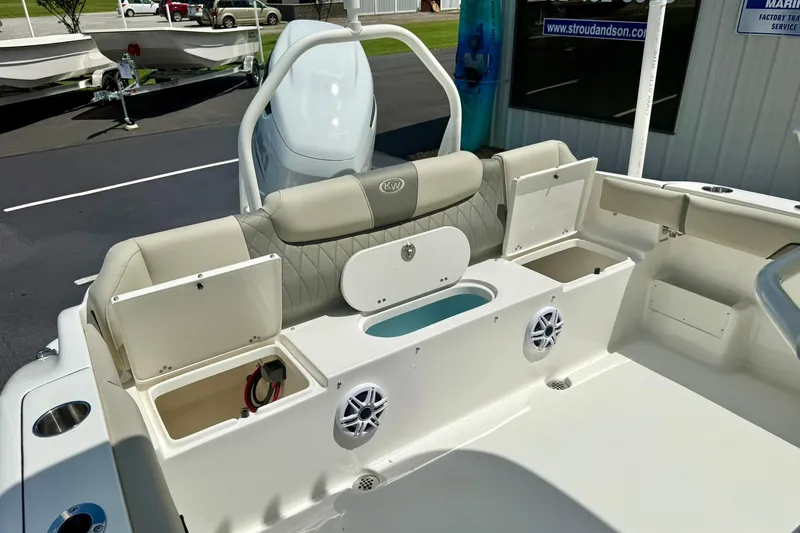 Slide: The Image of 2026 Key West 239 FS boat interior with beige cushioned seating and storage compartment. - 38