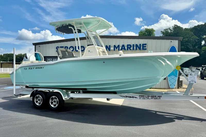 Slide: The Image of 2026 Key West 239 FS boat on trailer under blue sky. - 4