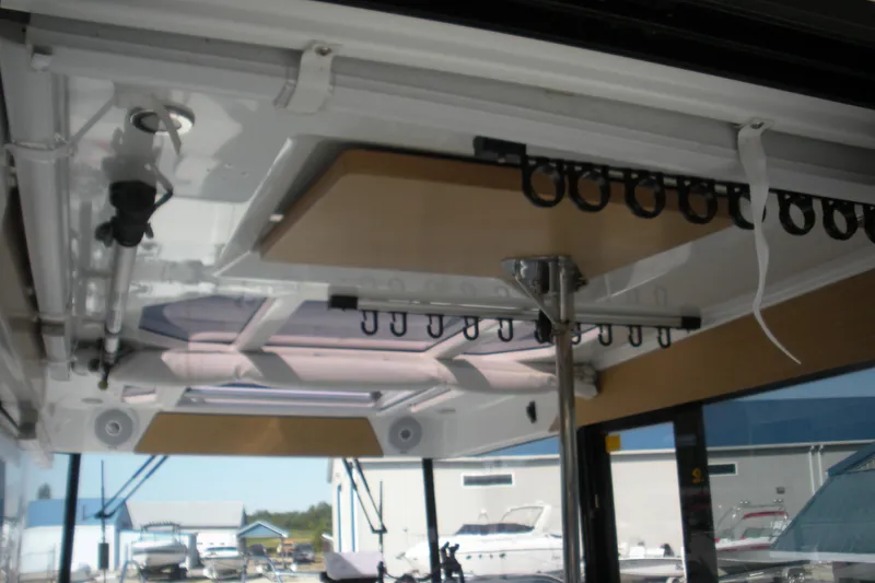 Slide: The Image of Interior view of a 2019 Beneteau Barracuda 9 boat, showcasing ceiling details and rod holders. - 11
