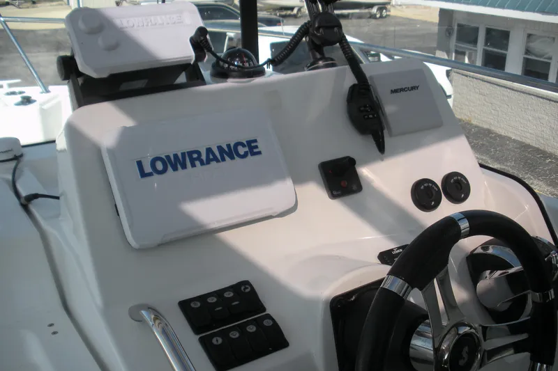 Slide: The Image of Control panel of a 2019 Beneteau Barracuda 9 with Lowrance and Mercury equipment. - 12