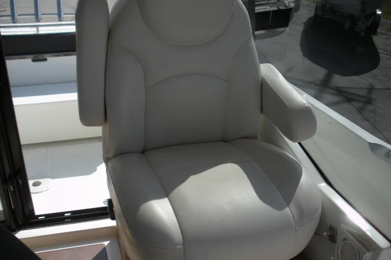 Slide: The Image of Comfortable captain's chair on 2019 Beneteau Barracuda 9 boat, featuring plush white upholstery. - 16