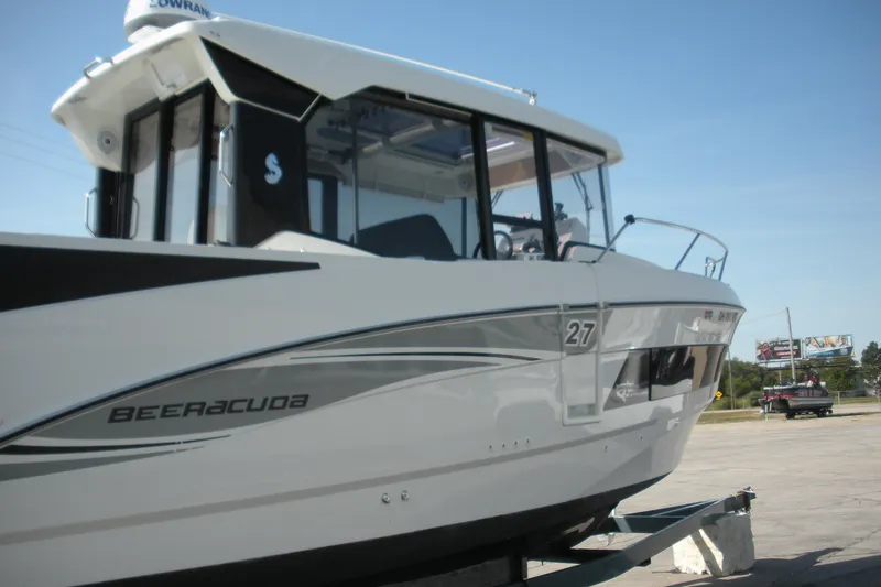 Slide: The Image of 2019 Beneteau Barracuda 9 boat on trailer, side view, clear sky background. - 2