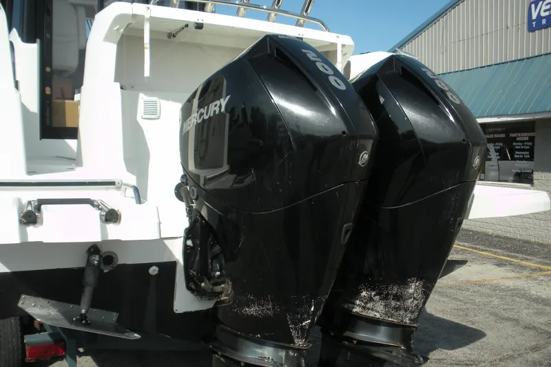 Slide: The Image of 2019 Beneteau Barracuda 9 with twin Mercury outboard engines, docked at a marina. - 20