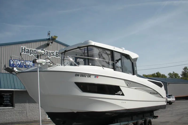 Slide: The Image of 2019 Beneteau Barracuda 9 boat on trailer at dealership, clear sky background. - 4