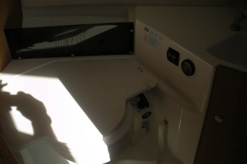 Slide: The Image of Interior of 2019 Beneteau Barracuda 9, featuring compact bathroom area with sink and controls. - 9