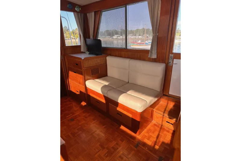 Slide: The Image of Interior of 1984 Grand Banks 42 Classic yacht with wooden finish and beige seating. - 6