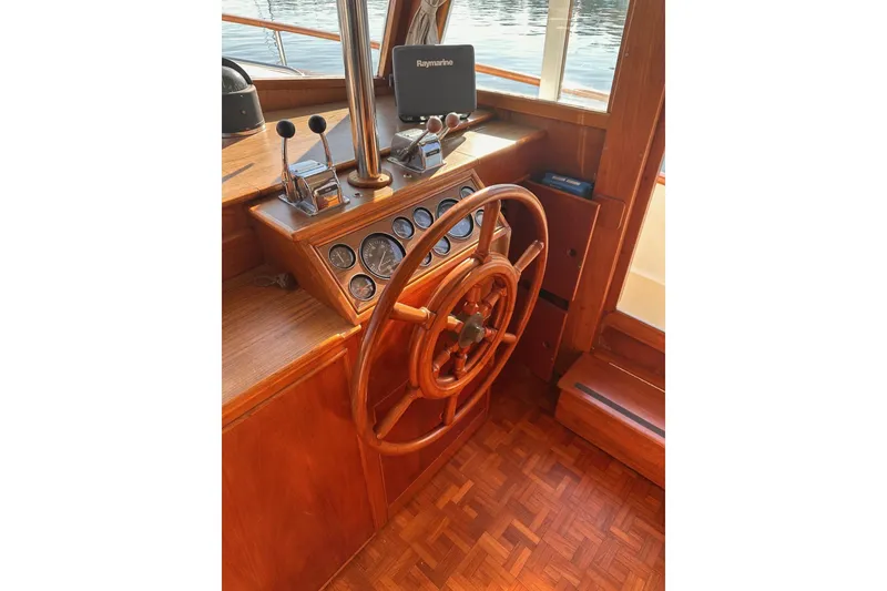Slide: The Image of 1984 Grand Banks 42 Classic helm with wooden wheel and navigation instruments. - 8