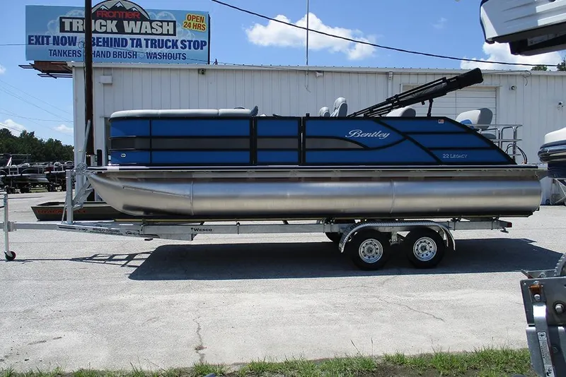 The Image of 2026 Bentley Pontoons Legacy 220 Quad Swingback on trailer, parked near truck wash. - 1