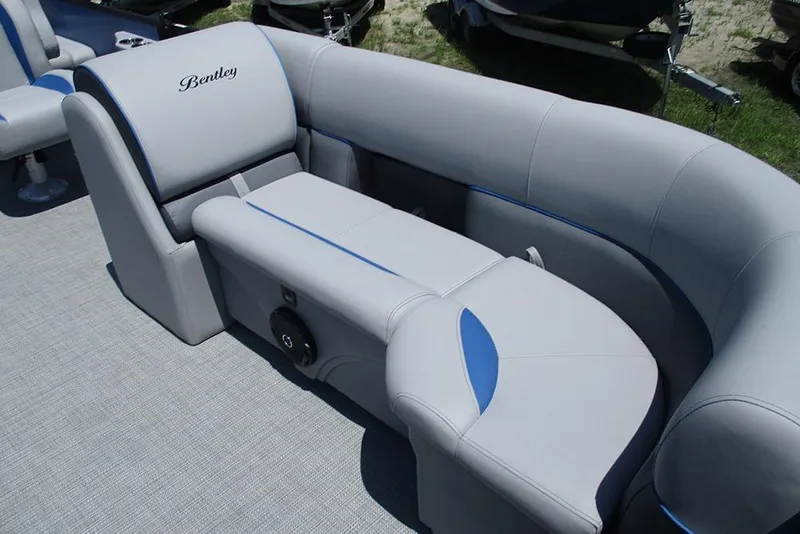 Slide: The Image of 2026 Bentley Pontoons Legacy 220 Quad Swingback with luxurious gray seating and blue accents. - 10