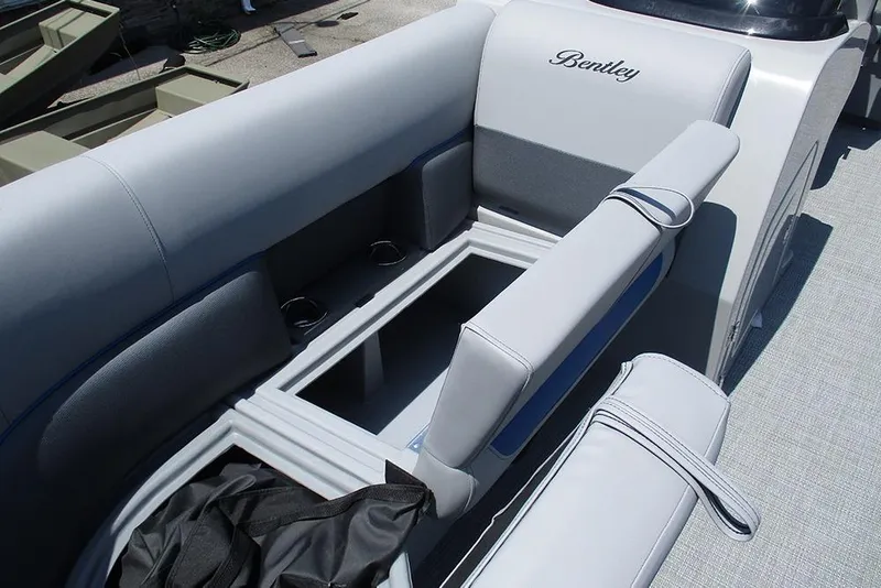Slide: The Image of 2026 Bentley Pontoons Legacy 220 Quad Swingback with open storage compartment and cushioned seating. - 16