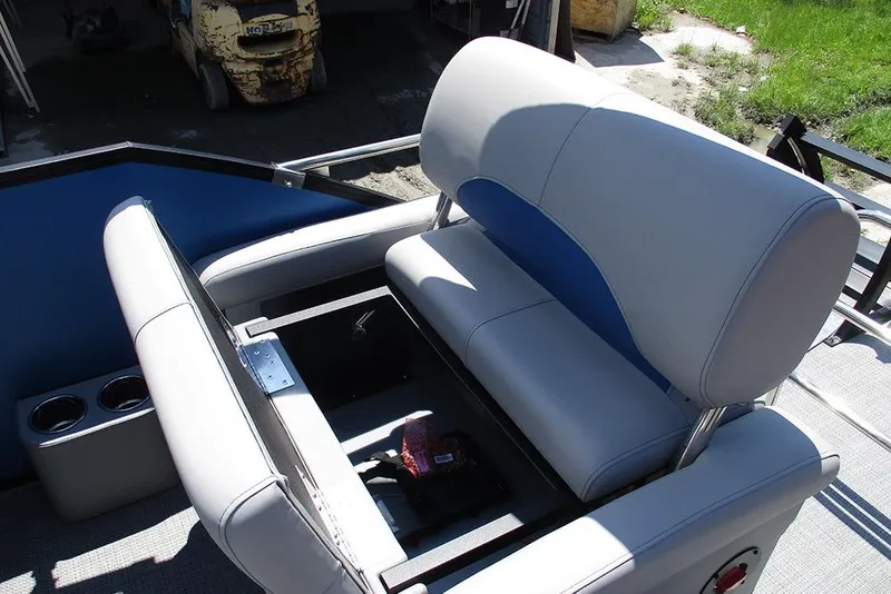 Slide: The Image of 2026 Bentley Pontoons Legacy 220 Quad Swingback interior seating with storage compartment. - 23