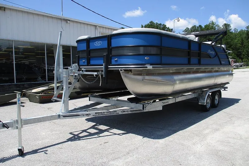 Slide: The Image of 2026 Bentley Pontoons Legacy 220 Quad Swingback on trailer, parked outdoors. - 3