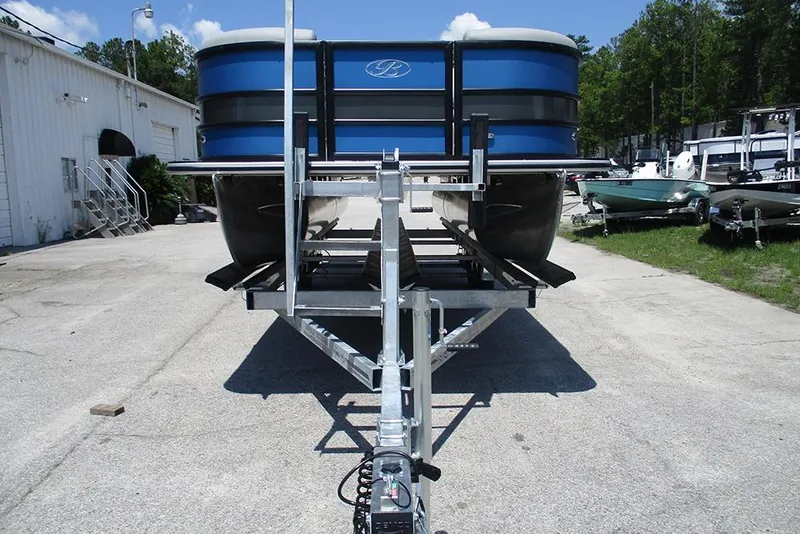 Slide: The Image of 2026 Bentley Pontoons Legacy 220 Quad Swingback on trailer, parked outdoors. - 4