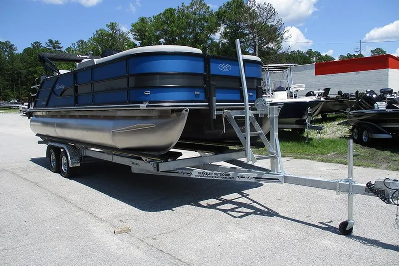 Slide: The Image of 2026 Bentley Pontoons Legacy 220 Quad Swingback on trailer, parked outdoors. - 5