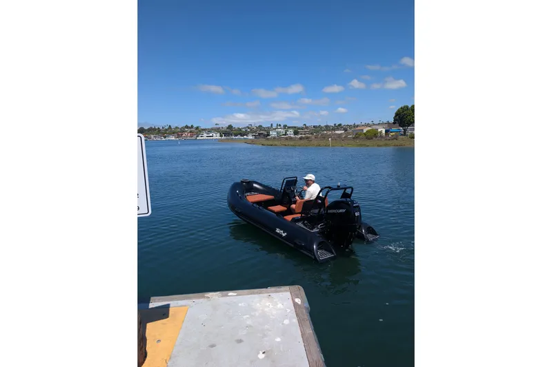 Slide: The Image of 2026 Tide Craft Custom Black & Tan Catalina 13 boat on water, clear sky background. - 11