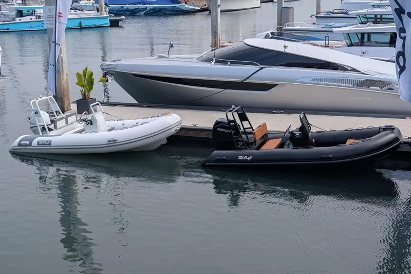 Slide: The Image of 2026 Tide Craft Custom Black & Tan Catalina 13 boat docked beside a white inflatable boat. - 7