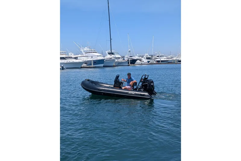 Slide: The Image of 2026 Tide Craft Custom Black & Tan Catalina 13 boat on water, marina background. - 3