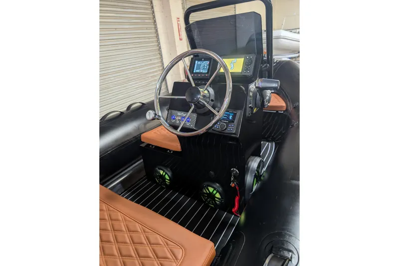 Slide: The Image of 2026 Tide Craft Custom Black & Tan Catalina 13 boat interior with modern dashboard and leather seating. - 9