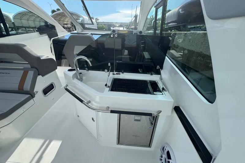 Slide: The Image of Interior of 2022 Beneteau Gran Turismo 32 yacht with kitchenette and seating area. - 11