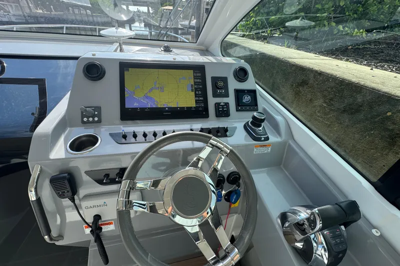 Slide: The Image of 2022 Beneteau Gran Turismo 32 cockpit with navigation display and steering wheel. - 15