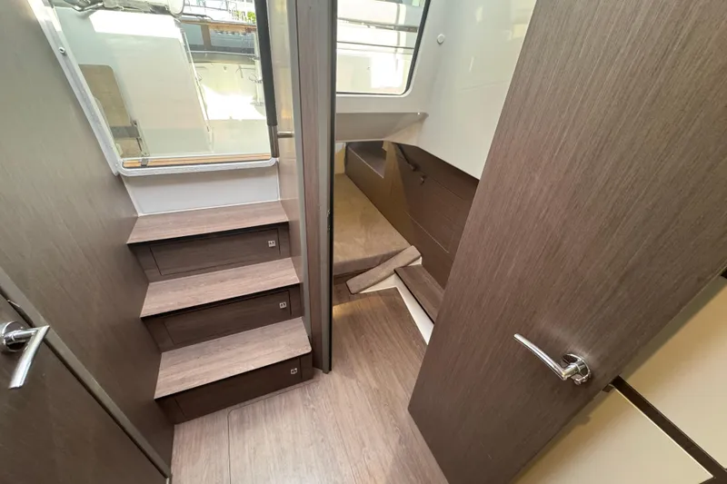 Slide: The Image of Interior of 2022 Beneteau Gran Turismo 32 yacht, featuring wooden stairs and modern design. - 16