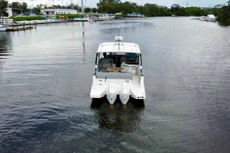Slide: The Image of 2022 Beneteau Gran Turismo 32 yacht on calm water, rear view. - 2