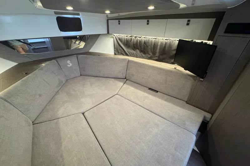 Slide: The Image of Interior of 2022 Beneteau Gran Turismo 32 with cozy seating and TV. - 21