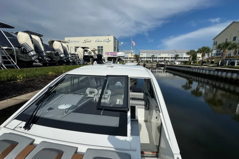 Slide: The Image of 2022 Beneteau Gran Turismo 32 docked at marina, showcasing sleek design and modern features. - 22
