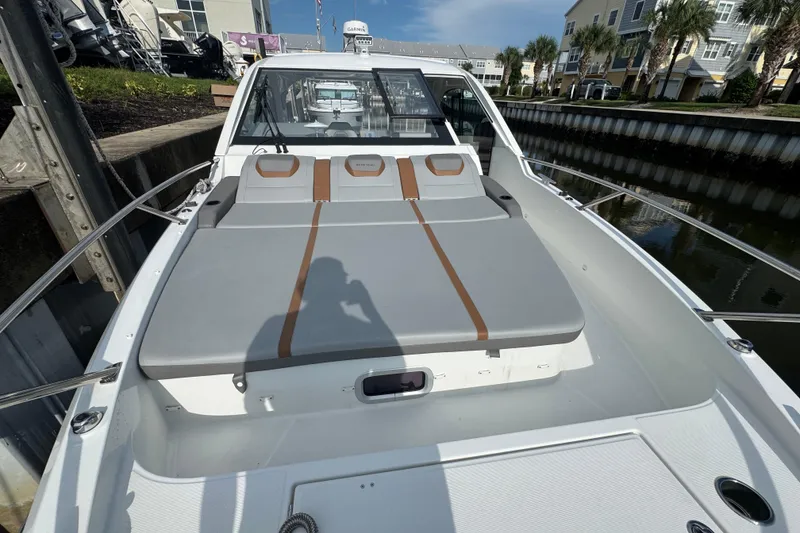 Slide: The Image of 2022 Beneteau Gran Turismo 32 boat with sunbed, docked in a marina. - 24