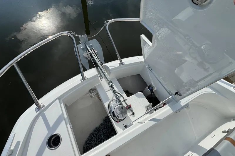 Slide: The Image of 2022 Beneteau Gran Turismo 32 anchor compartment with open hatch and visible chain. - 25