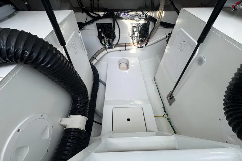 Slide: The Image of Engine compartment of 2022 Beneteau Gran Turismo 32 with visible wiring and ventilation hoses. - 29