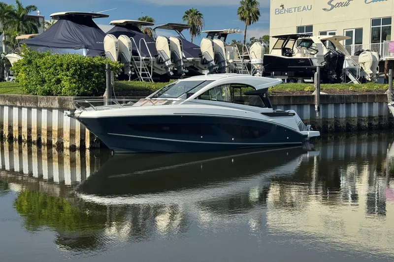 Slide: The Image of 2022 Beneteau Gran Turismo 32 yacht docked at a marina, surrounded by other boats. - 7