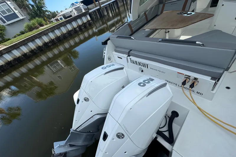 Slide: The Image of 2022 Beneteau Gran Turismo 32 with dual outboard engines docked by a canal. - 8