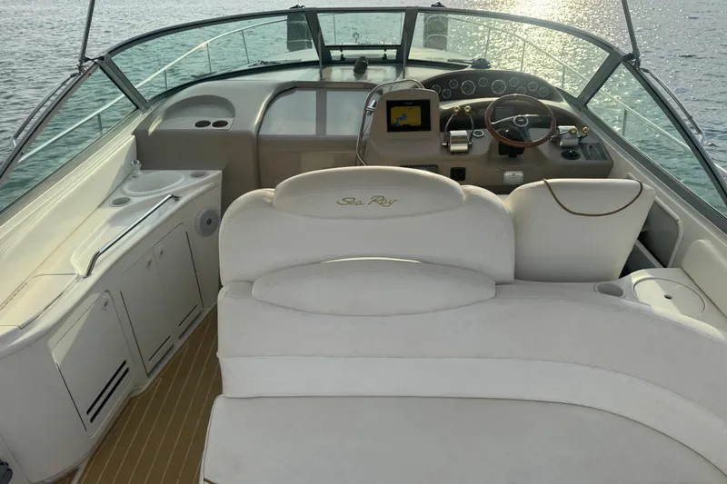 Slide: The Image of Cockpit of 2000 Sea Ray 340 Sundancer with helm, seating, and water view. - 10