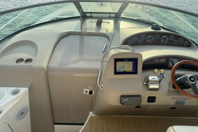 Slide: The Image of 2000 Sea Ray 340 Sundancer helm with navigation system and wooden steering wheel. - 16