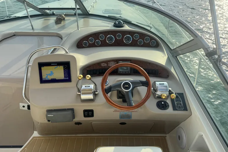 Slide: The Image of Cockpit of 2000 Sea Ray 340 Sundancer with steering wheel and navigation system. - 17
