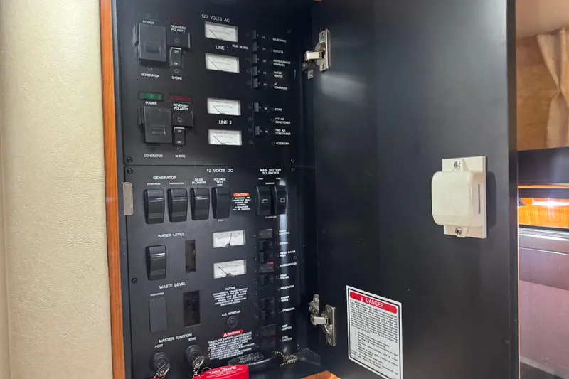 Slide: The Image of Electrical control panel inside 2000 Sea Ray 340 Sundancer boat, featuring switches and meters. - 18