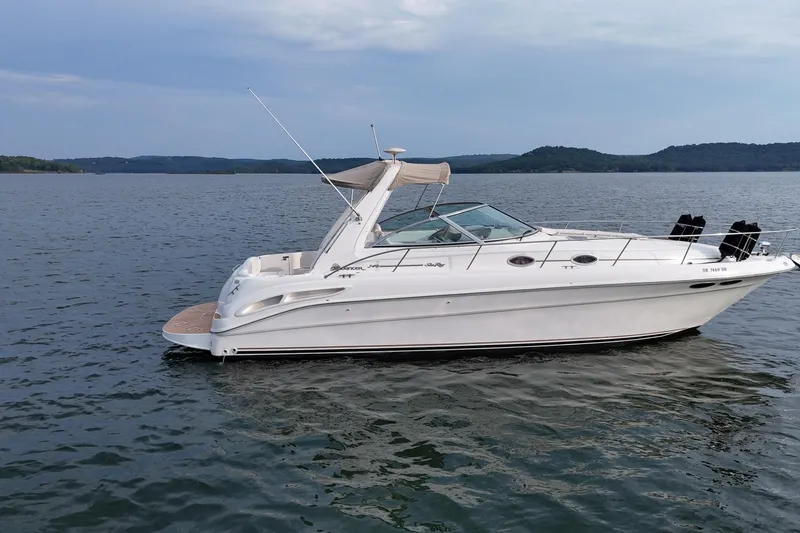 Slide: The Image of 2000 Sea Ray 340 Sundancer boat on calm lake with distant hills. - 2
