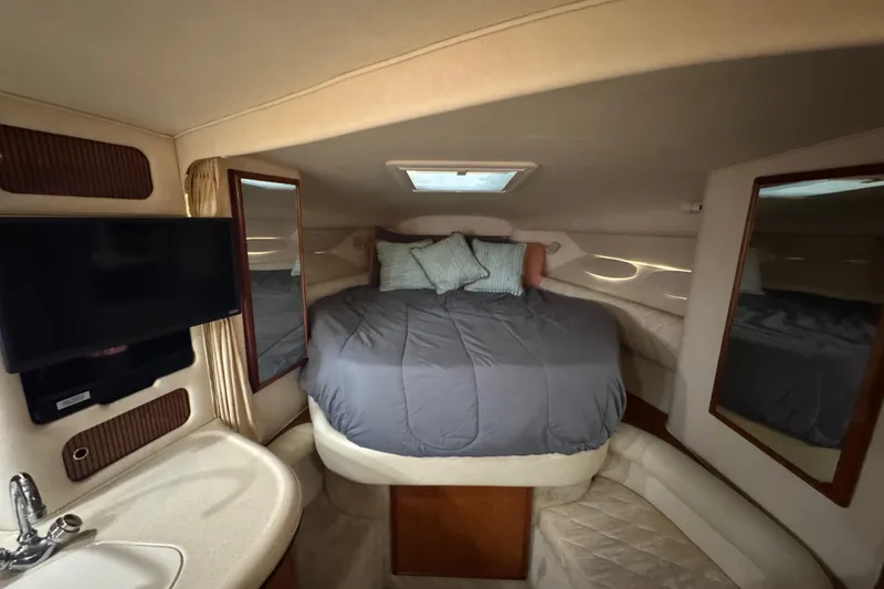 Slide: The Image of Interior cabin of 2000 Sea Ray 340 Sundancer with bed, TV, and sink. - 20
