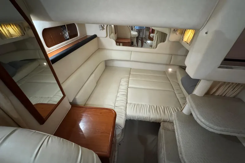 Slide: The Image of Interior of 2000 Sea Ray 340 Sundancer yacht with beige seating and wooden accents. - 21