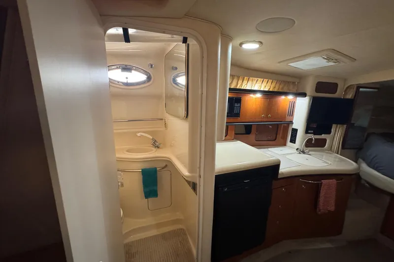 Slide: The Image of Interior of 2000 Sea Ray 340 Sundancer yacht with kitchenette and bathroom. - 22