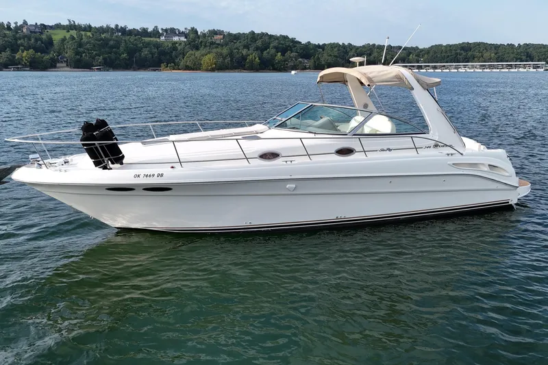 Slide: The Image of 2000 Sea Ray 340 Sundancer boat on a calm lake with scenic background. - 3