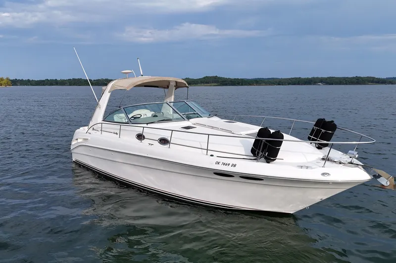 Slide: The Image of 2000 Sea Ray 340 Sundancer boat on calm water under a clear sky. - 5