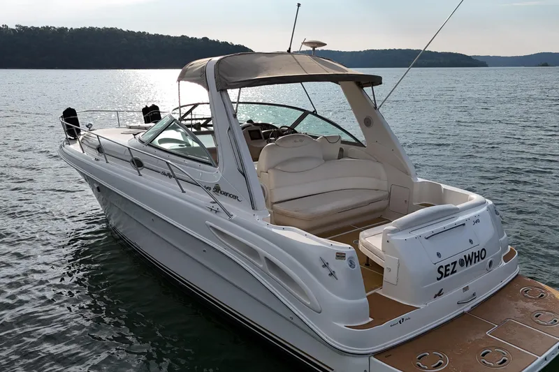 Slide: The Image of 2000 Sea Ray 340 Sundancer boat on calm water, featuring spacious seating and sleek design. - 7