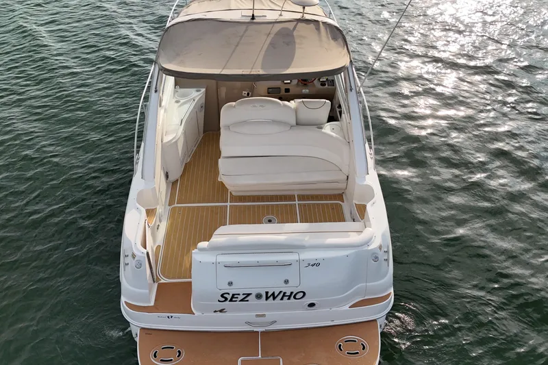 Slide: The Image of 2000 Sea Ray 340 Sundancer yacht on water, rear view with seating and deck. - 8